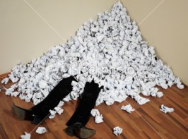 stock-photo-12198459-businessman-buried-in-mountain-of-crumpled-papers